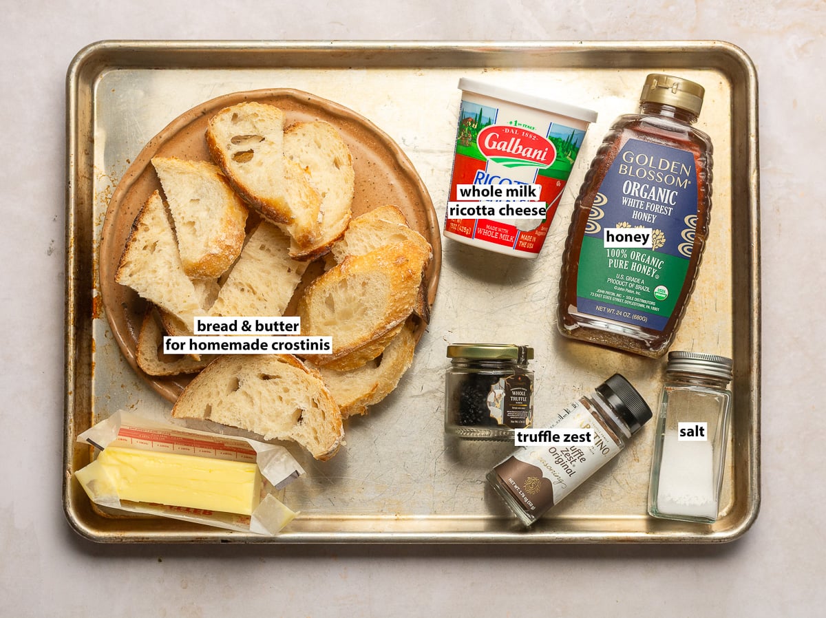 ingredients for truffle whipped ricotta with honey - whole milk ricotta, truffle zest, honey, salt and bread and butter for crostinis