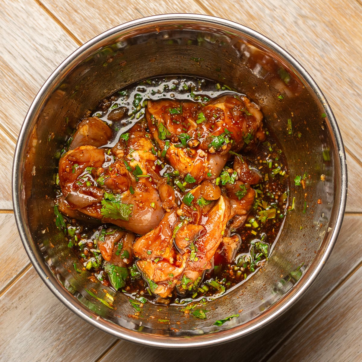 bowl of chicken thighs in cilantro lime chicken marinade.