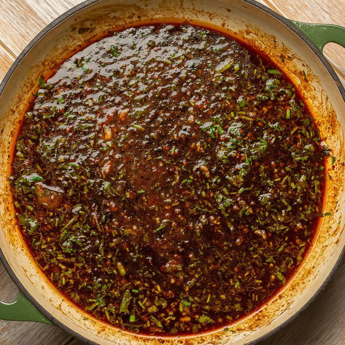 reducing cilantro lime chicken marinade in a pan.