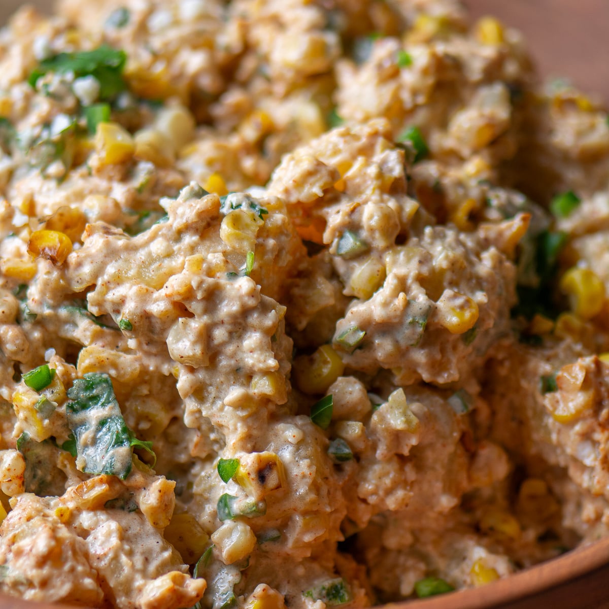 Mexican street corn potato salad in a wooden bowl.