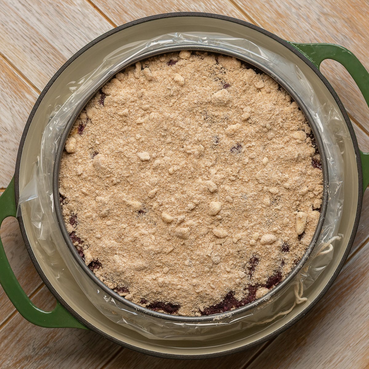 lemon blueberry cheesecake crumble in a water bath to be baked.