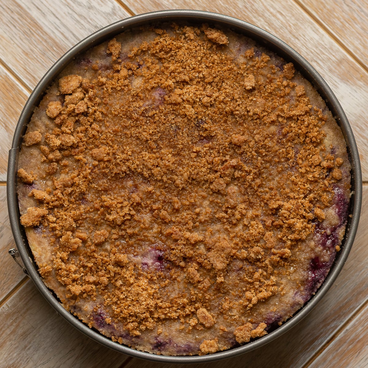baked lemon blueberry crumble cheesecake in a springform pan.