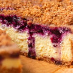 blueberry lemon crumble cheesecake on parchment paper.
