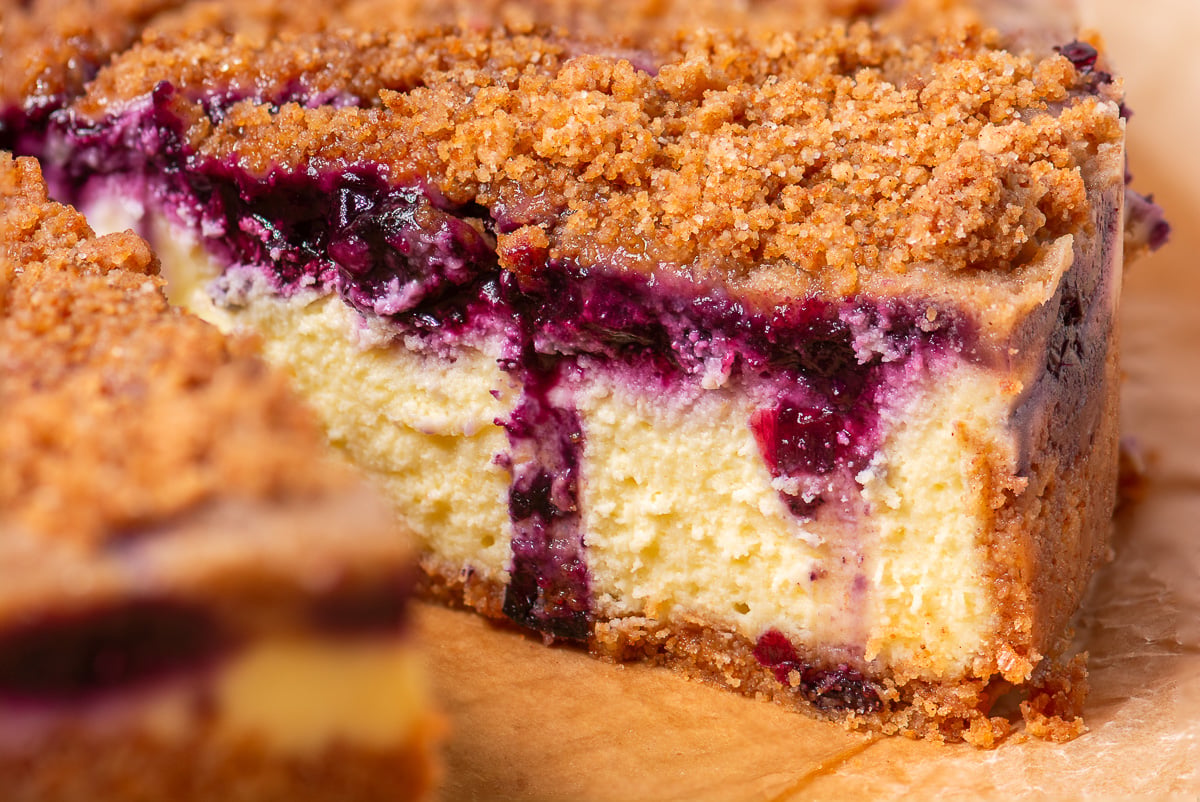blueberry lemon crumble cheesecake on parchment paper.