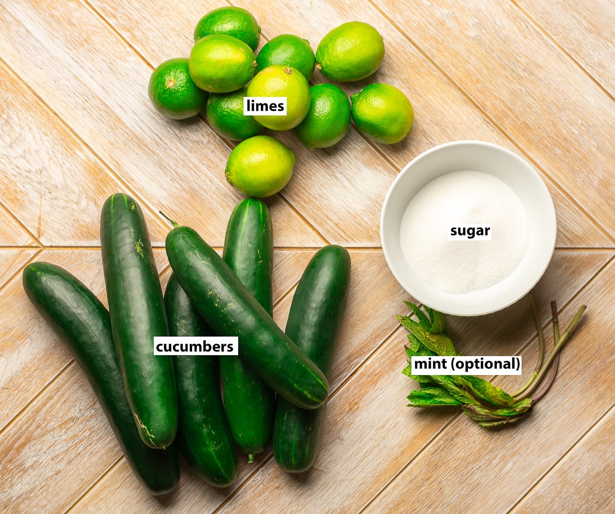 ingredients for cucumber limeade - cucumbers, limes, sugar and mint.