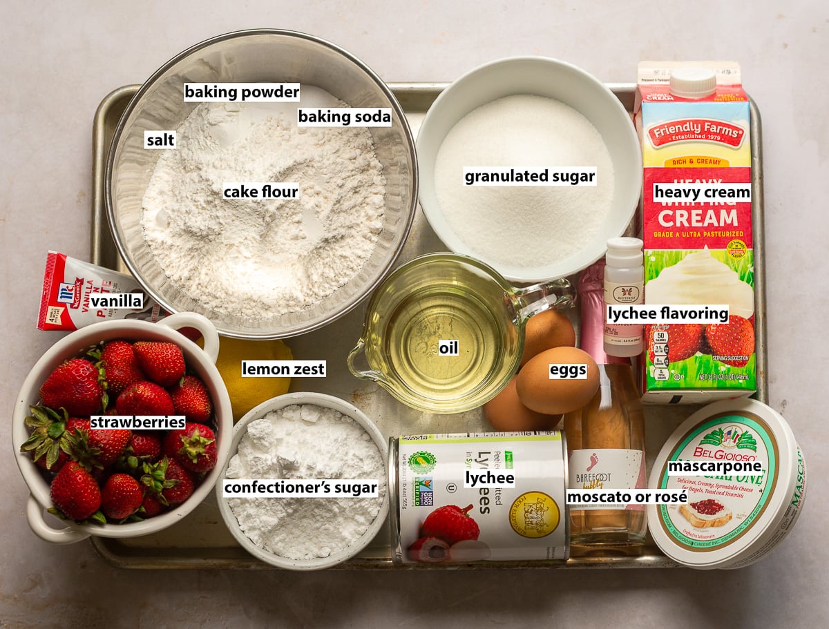 ingredients for lychee cake - lychee, lychee extract, strawberries, rosé, cake flour, eggs, oil, baking powder, baking soda, salt, vanilla, lemon zest, mascarpone, heavy cream.