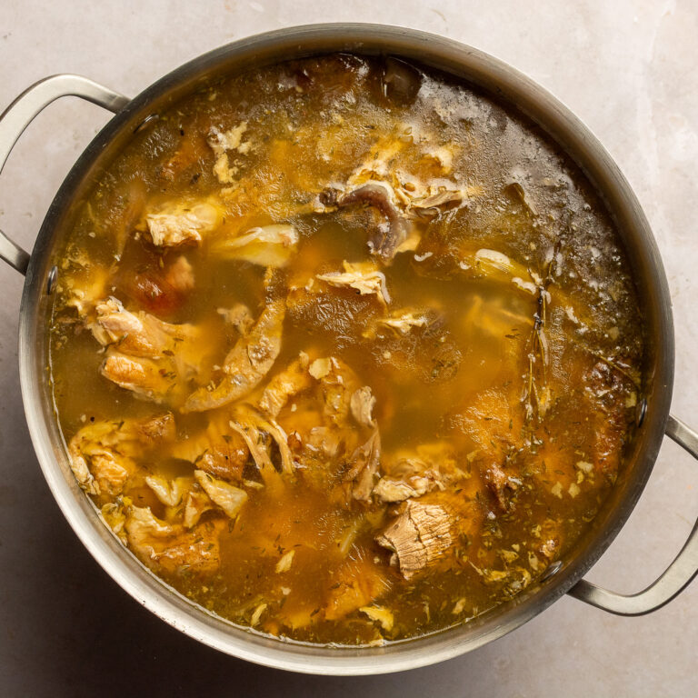 chicken stock from rotisserie chicken in a stainless steel stockpot.