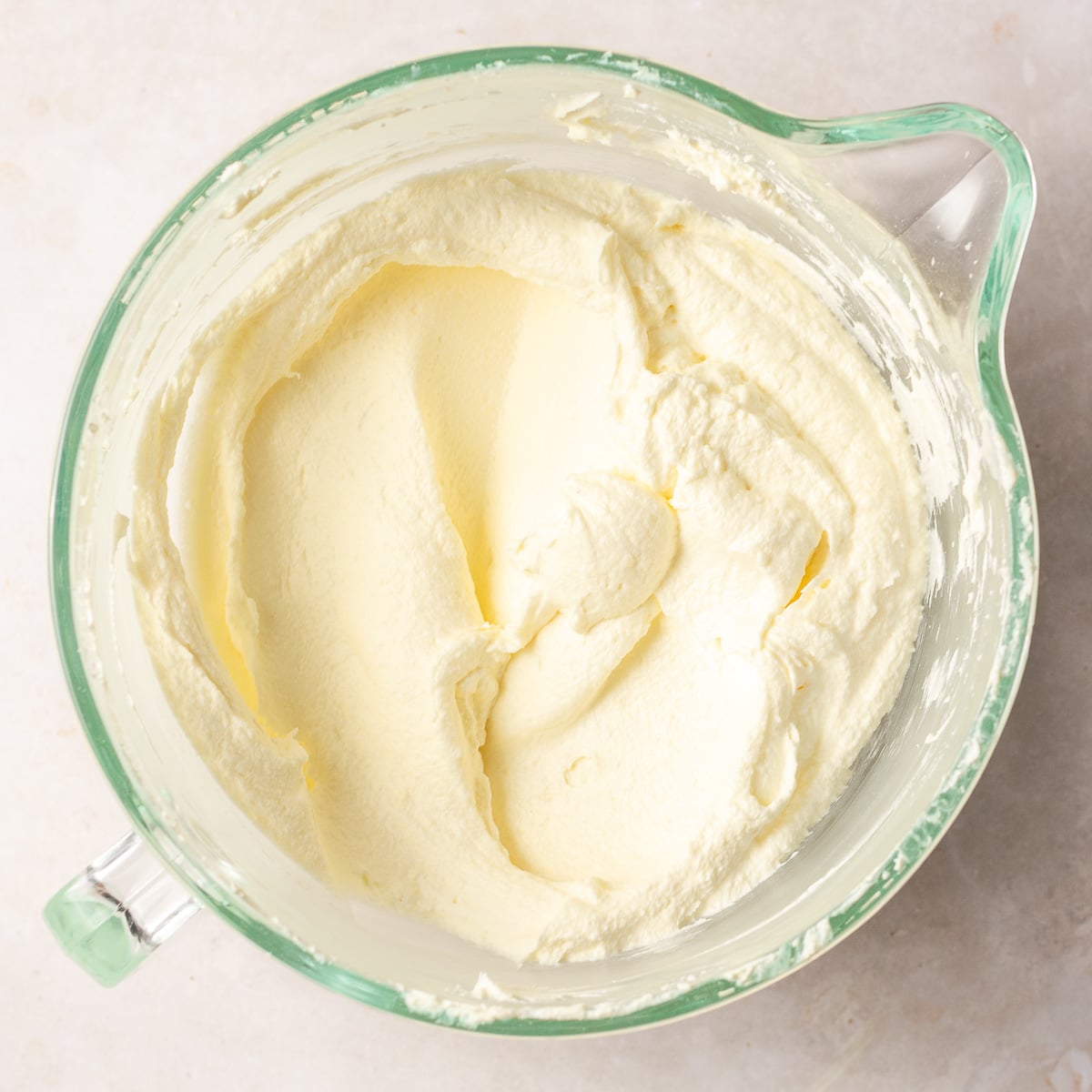 cream cheese frosting in a glass bowl.