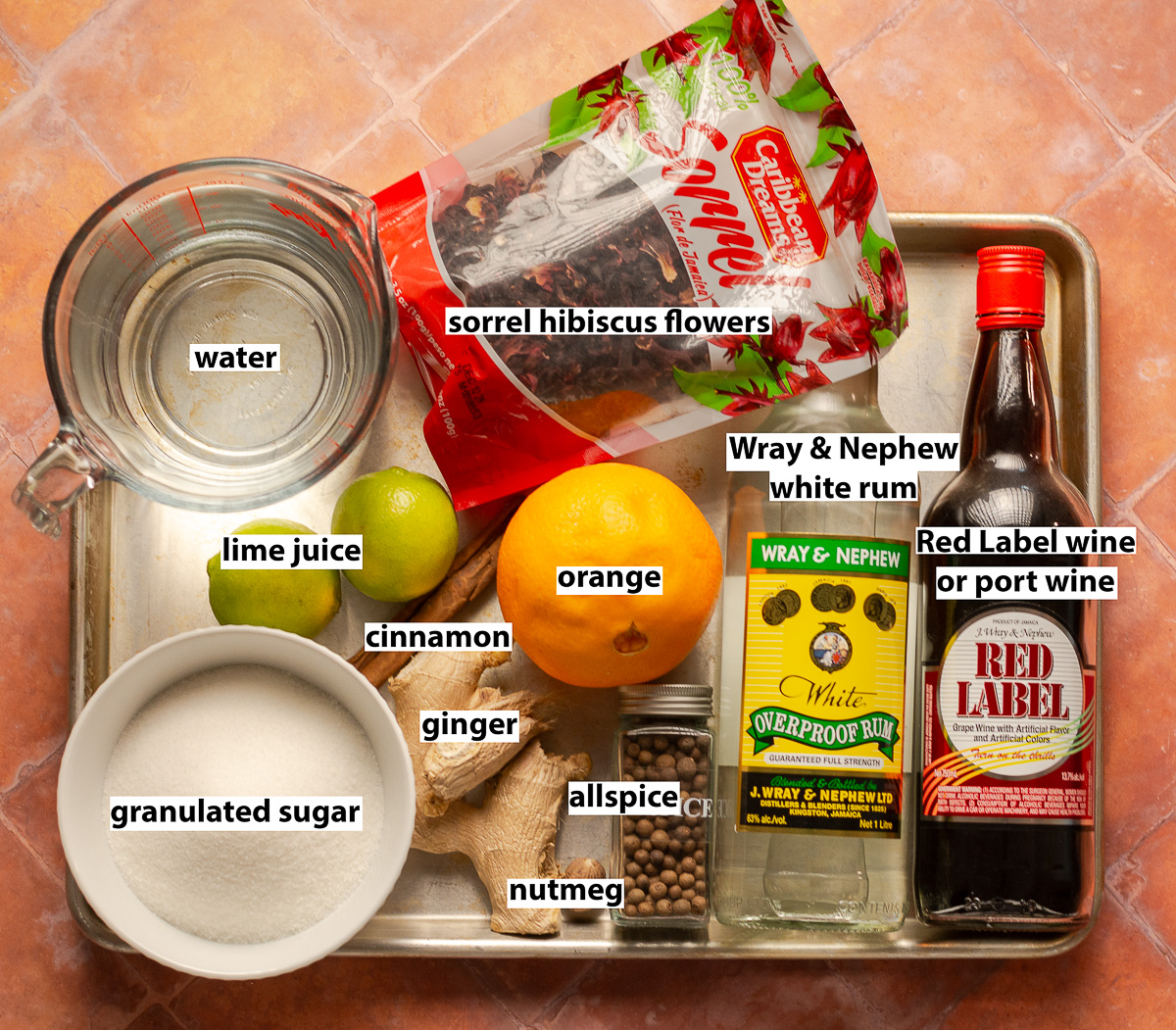 ingredients for Jamaican sorrel - sorrel hibiscus flowers, orange, lime juice, cinnamon, allspice, nutmeg, ginger, water, granulated sugar, Wray & nephew white rum & Red label wine.