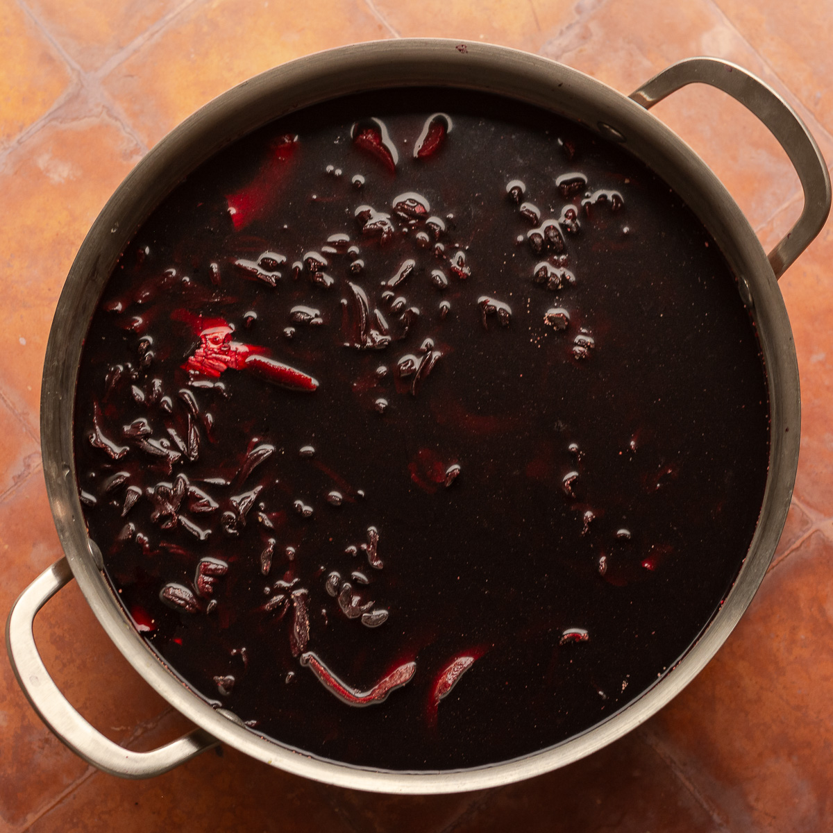 steeped jamaican sorrel in a stockpot.